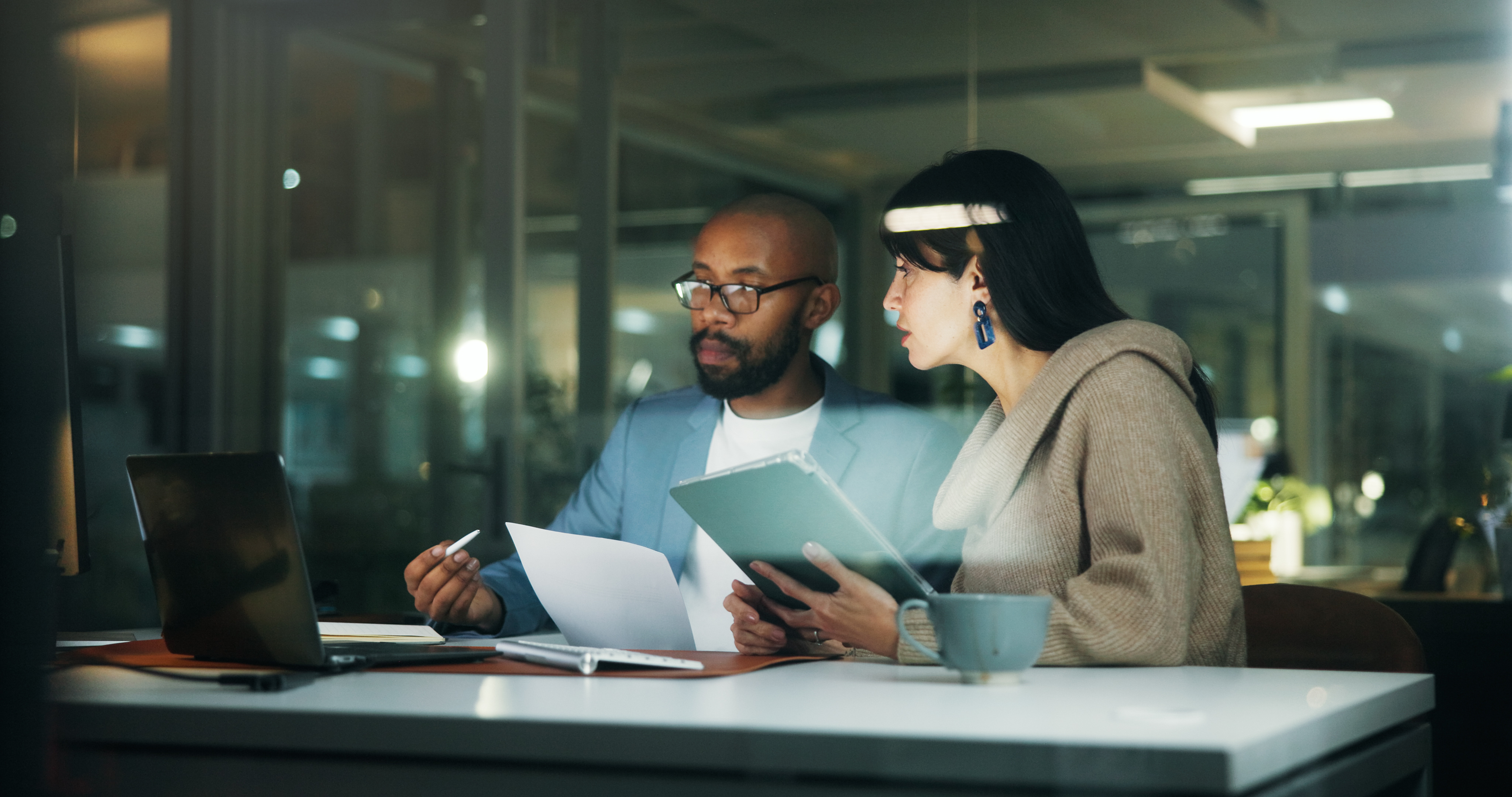 A team reconciling finance reports and operational records after hours—the hidden cost of disconnected systems.